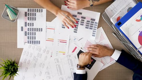 Corporate Financial Team Analyzing Charts and Diagrams with Market Sales