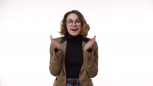 Excited Young Woman Smiling and Laughing in Studio