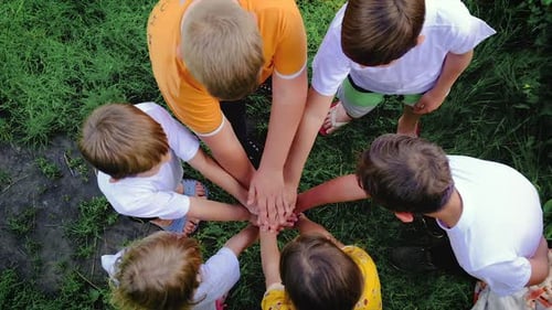 Children Putting Hands Together in a Circle