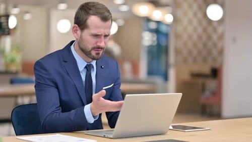 Loss, Businessman Reacting To Failure on Laptop in Office