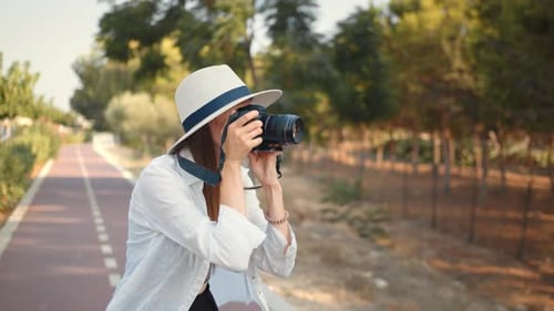 Young Woman Taking Pictures in Nature