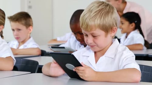 Children Using Tablets in Classroom at School