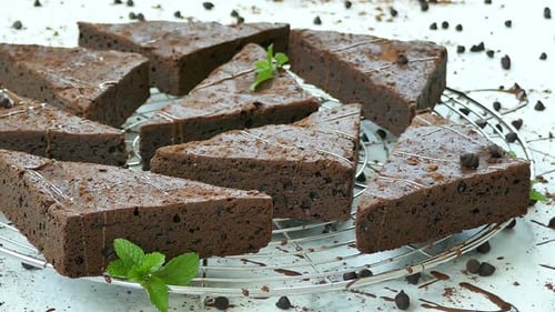 Delicious Chocolate Brownies with Mint Leaves Close Up
