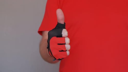 Hand Wearing Glove Gives Thumbs Up Gesture