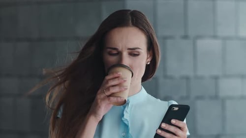 Business Woman Using Smartphone in City. Manager Standing on Street with Coffee