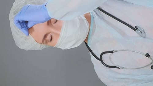 Concerned Doctor in Surgical Mask Looking at Camera