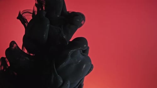 Abstract Black Ink Diffusing in Red Liquid