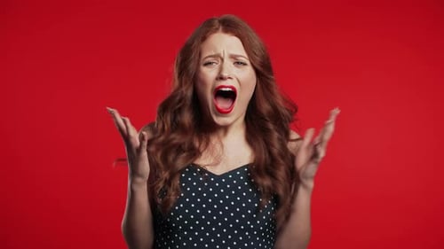 Close Up of Young Frightened Screaming Girl Shocked Isolated Over Red