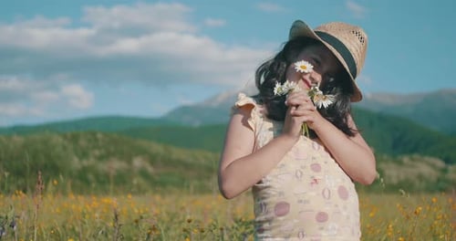 Girl Holding Daisies in a Sunny Meadow