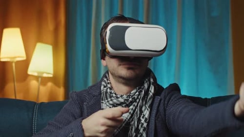 Young Man Using Virtual Reality Headset at Home