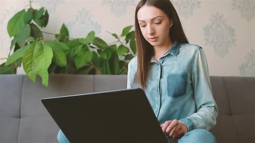 Woman Working on Laptop at Home