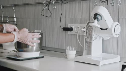 Woman Chef Making Dough Putting a Bowl Under the Blender