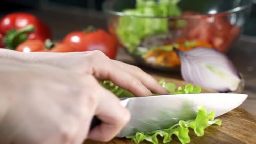 Fresh Lettuce Being Chopped on a Wooden Board