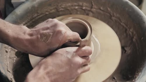 Craftsman Shaping Clay on a Pottery Wheel