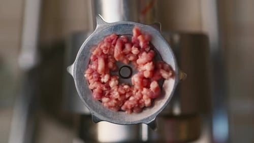 Ground Beef is Squeezed Out of a Meat Grinder