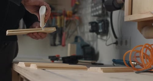 Carpenter Applies Wood Glue to the Timber Billet Craftsman at Workshop Gluing Wood Surfaces
