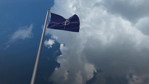 NATO Flag Waving in Cloudy Sky