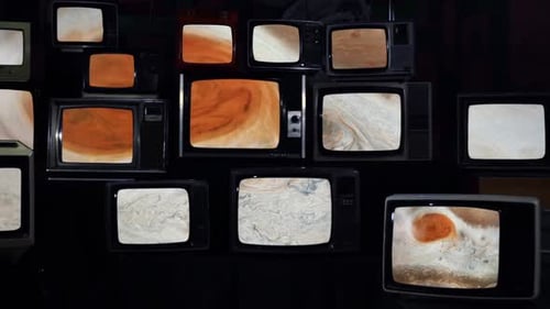 Pile of Vintage Televisions Showing Various Imagery