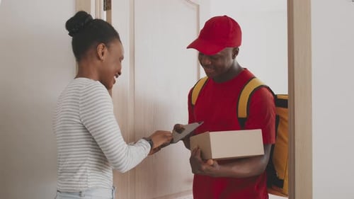Delivery Man Giving Package to Woman at Door