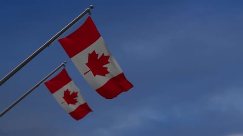Canada flags in the blue sky - 2K