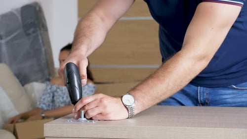 Close Up Man Carefully Assembling Furniture