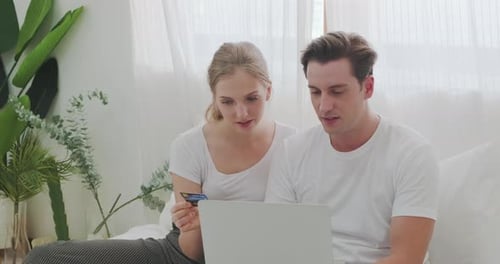 Couple Shopping Online With Laptop and Credit Card