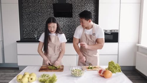 Couple Making Healthy Salad Together in Kitchen