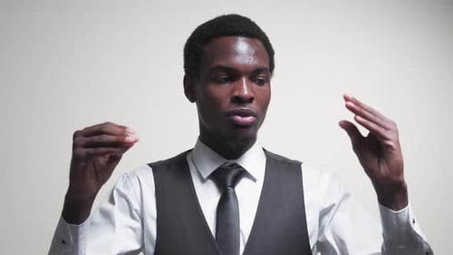 Man Gesturing While Talking Indoors