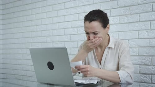 Woman Frustrated with Bills at Computer