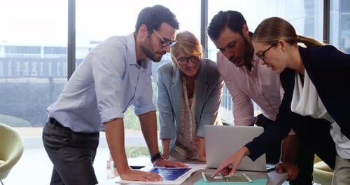 Professionals Collaborating on Project in Modern Office