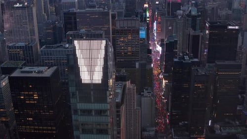 Close Up View of New Manhattan Skyscraper with Times Square and City Lights Glowing in the