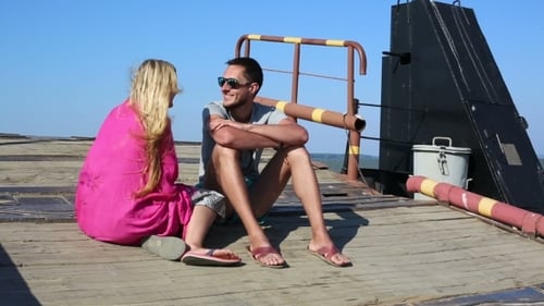 Young Couple Relaxing and Talking Near the Ocean
