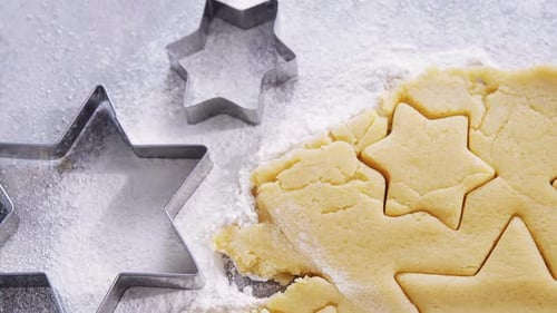 Raw cookie dough with star shape and cutter