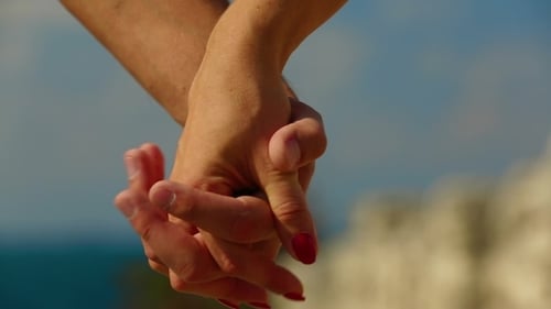 Couple On Beach Holding Hands