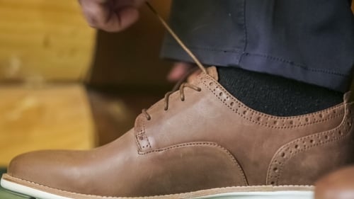Man Tying Laces on Brown Leather Dress Shoe