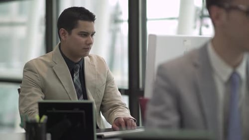 A Hispanic Man Works In A Attractive Modern Office (3 Of 4)