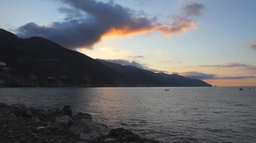 Coastal Waters at Sunrise with Mountain Backdrop