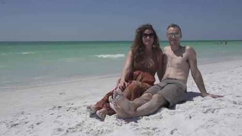 Couple Relaxing On A Morning Beach (2 Of 4)