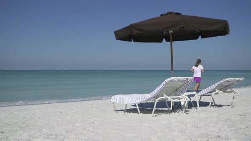 People Walk By An Umbrella At A Beach Resort (3 Of 3)