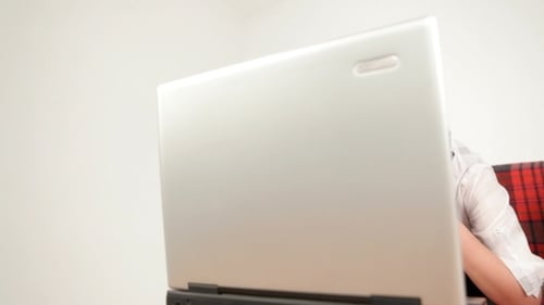 Woman with Headset using Laptop on Couch