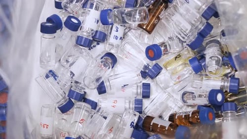 Laboratory Vials Piled in a Bin