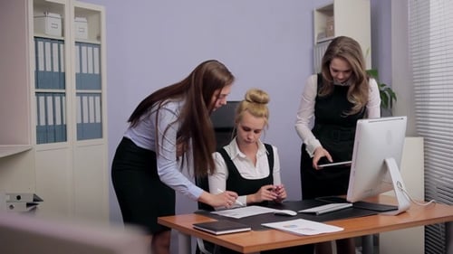 Three Young Women Working Together in Modern Office