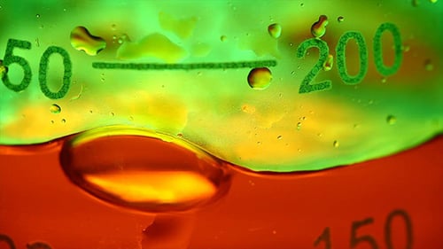 Liquid Pouring Into Clear Container Macro Shot