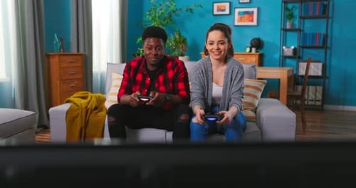 Friends Laughing, Playing Video Games at Home