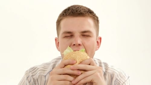 Young Adult Eating a Burger Close Up