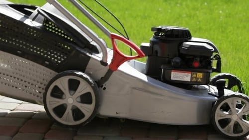 A Man Mowing The Lawn