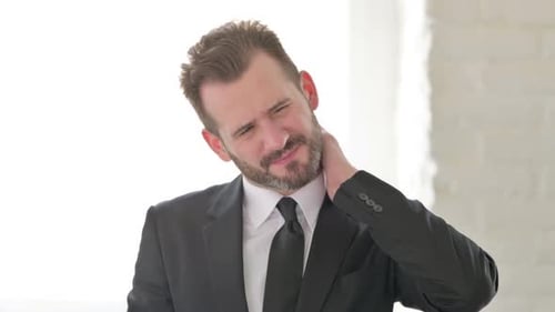 Tired Young Businessman with Neck Pain