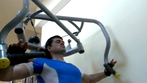 Man Exercising On Chest Press Machine