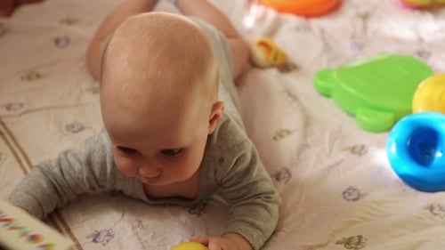 Baby Lying on Stomach with Toys