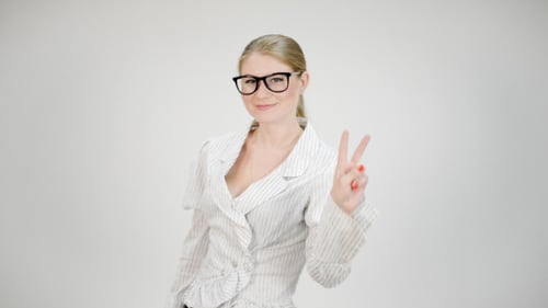 Woman Giving Peace Sign in Front of White Background